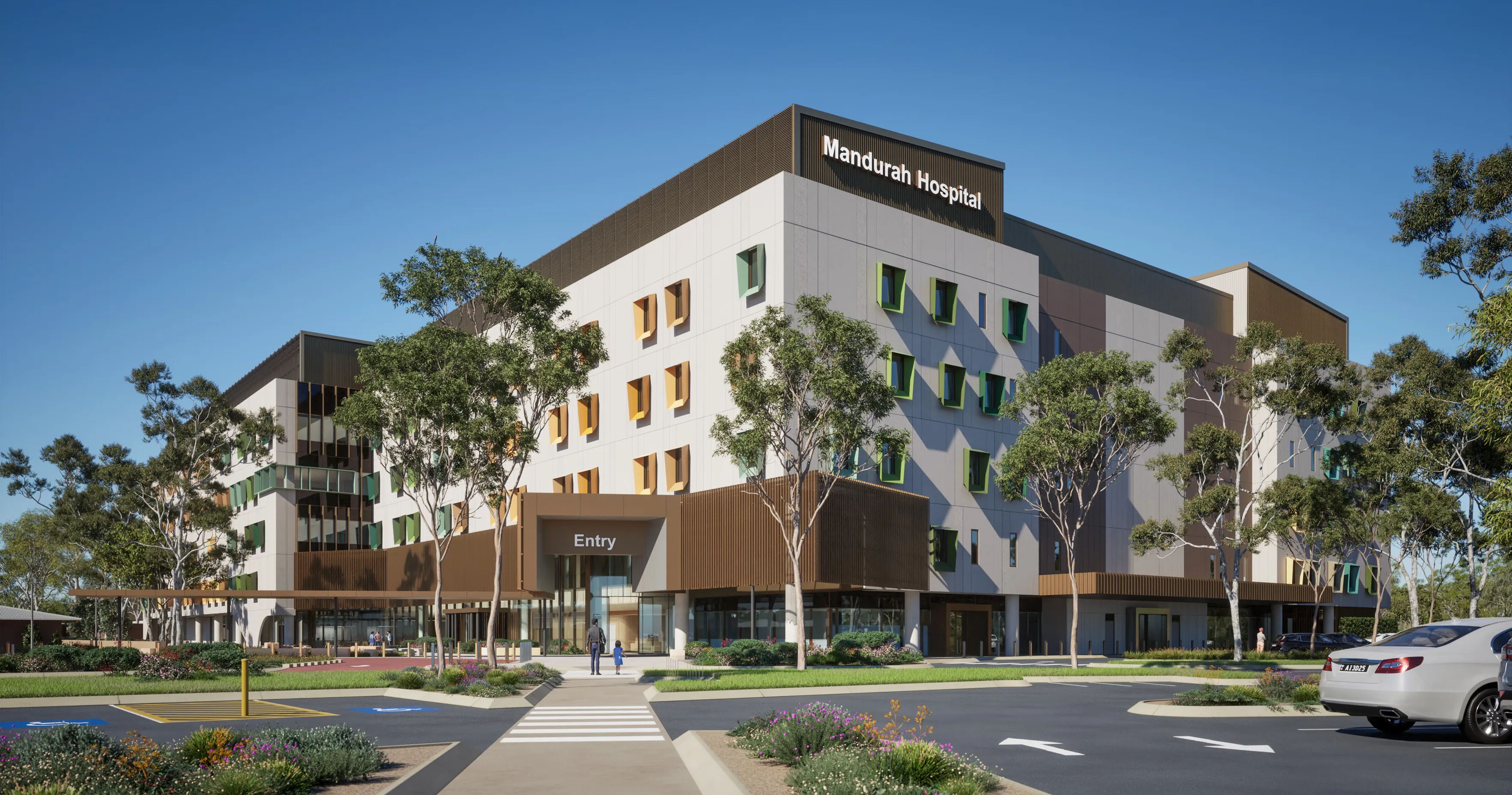a hospital with trees and a road