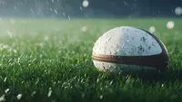 a football on grass in the rain