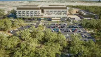 a building with many cars in a parking lot