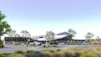 a building with trees and a parking lot
