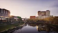 a body of water with buildings and trees
