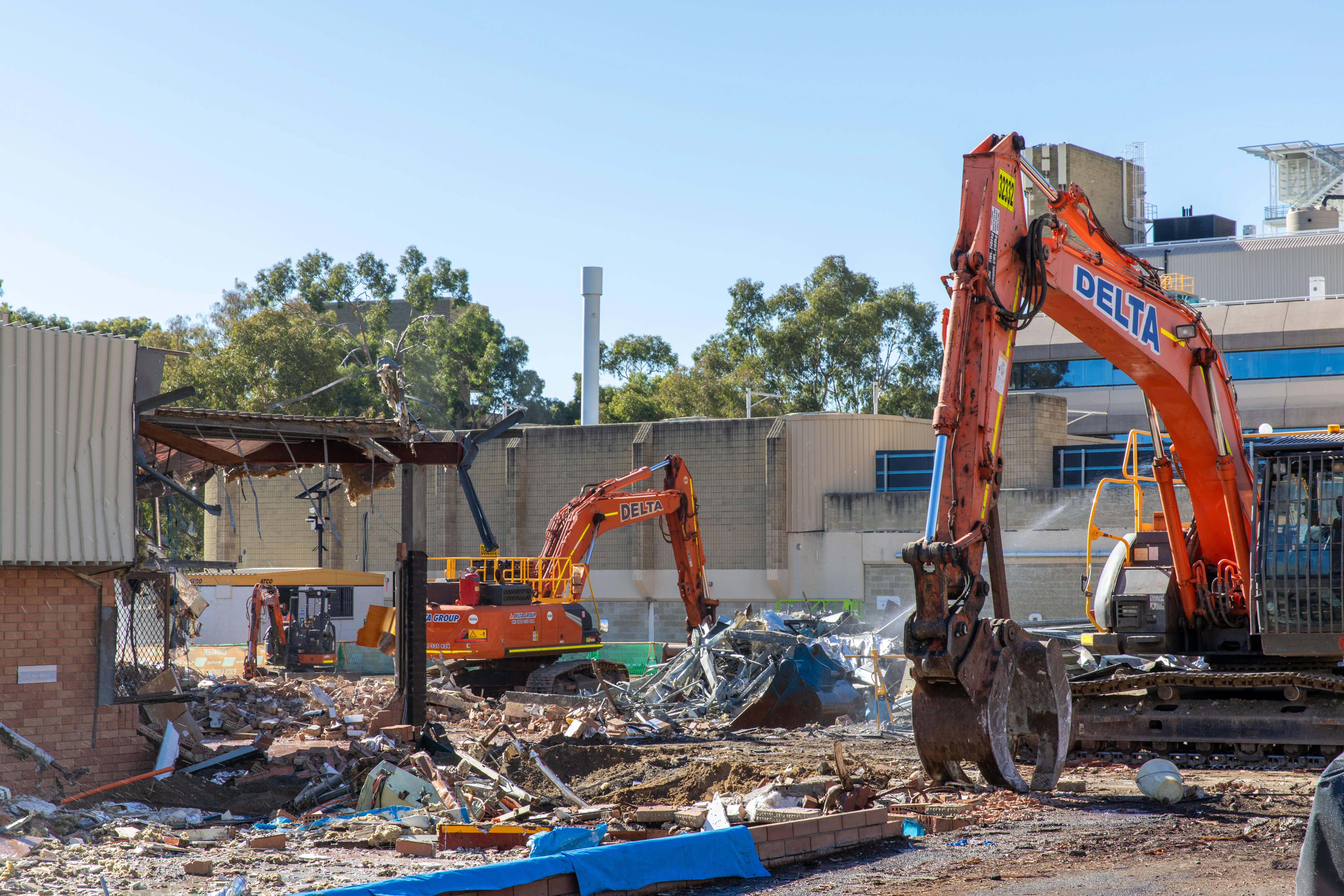 a construction site with excavators and debris