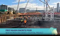 a group of people in orange vests at a construction site