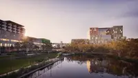a body of water with buildings and trees