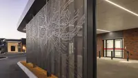 a metal wall with a design on it