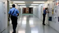 Two police officers in a hallway of a hospital
