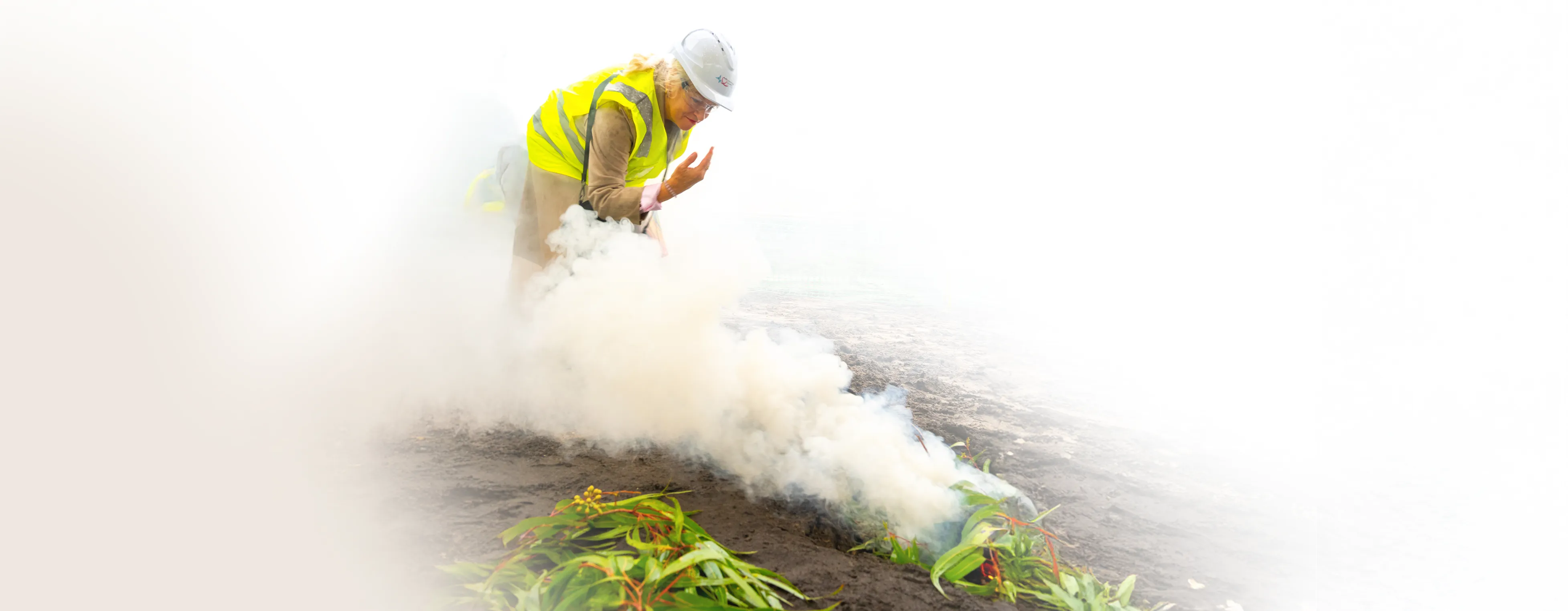 a woman wearing a safety vest and white helmet