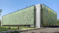 a building with many windows and a parking lot