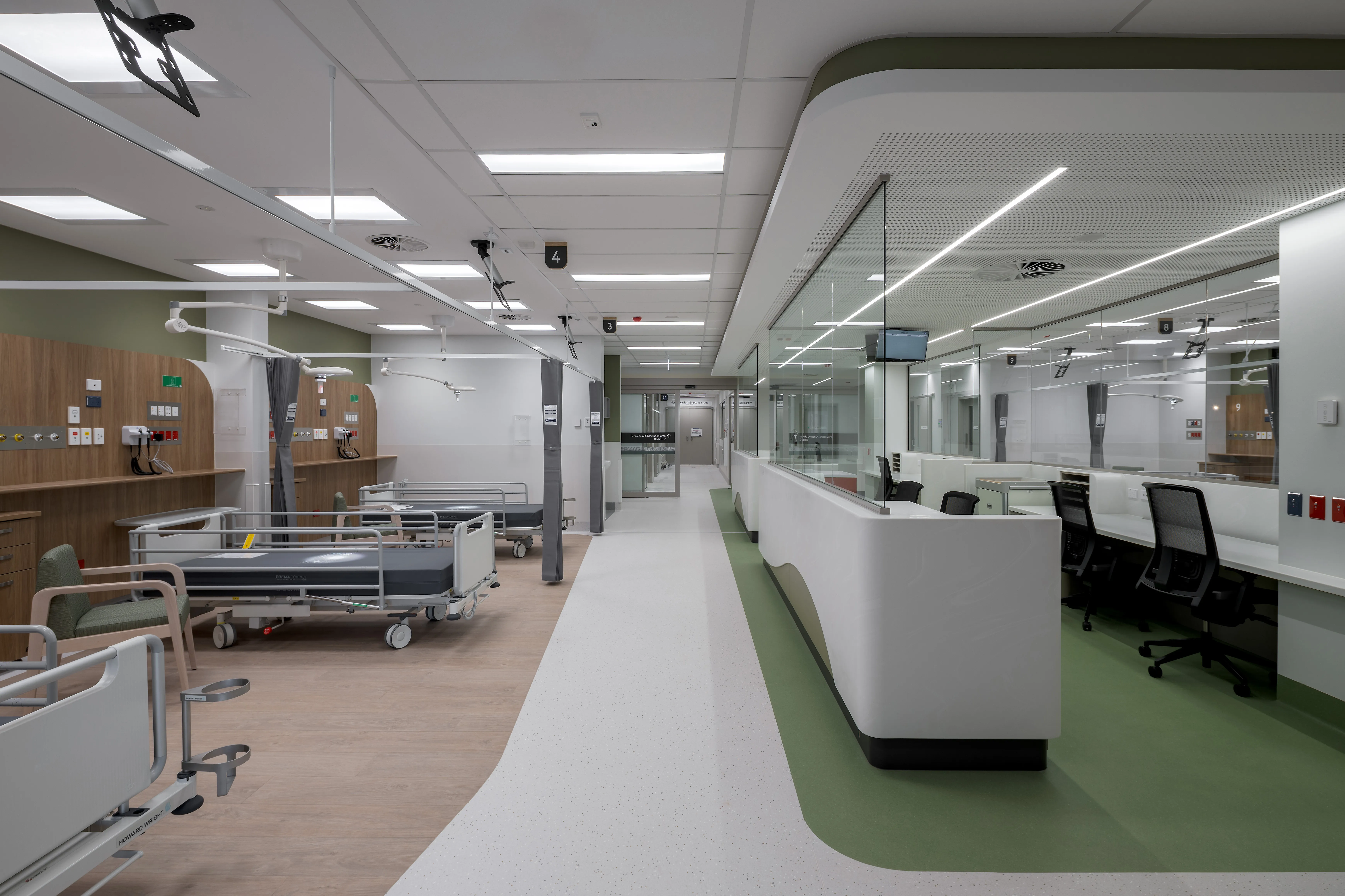a hospital room with beds and chairs
