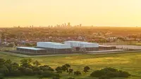 Aerial view of the studio buildings with the Perth city skyline in the background