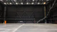 a large empty sound studio with stairs and metal walls