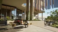 a group of people sitting at tables outside a building