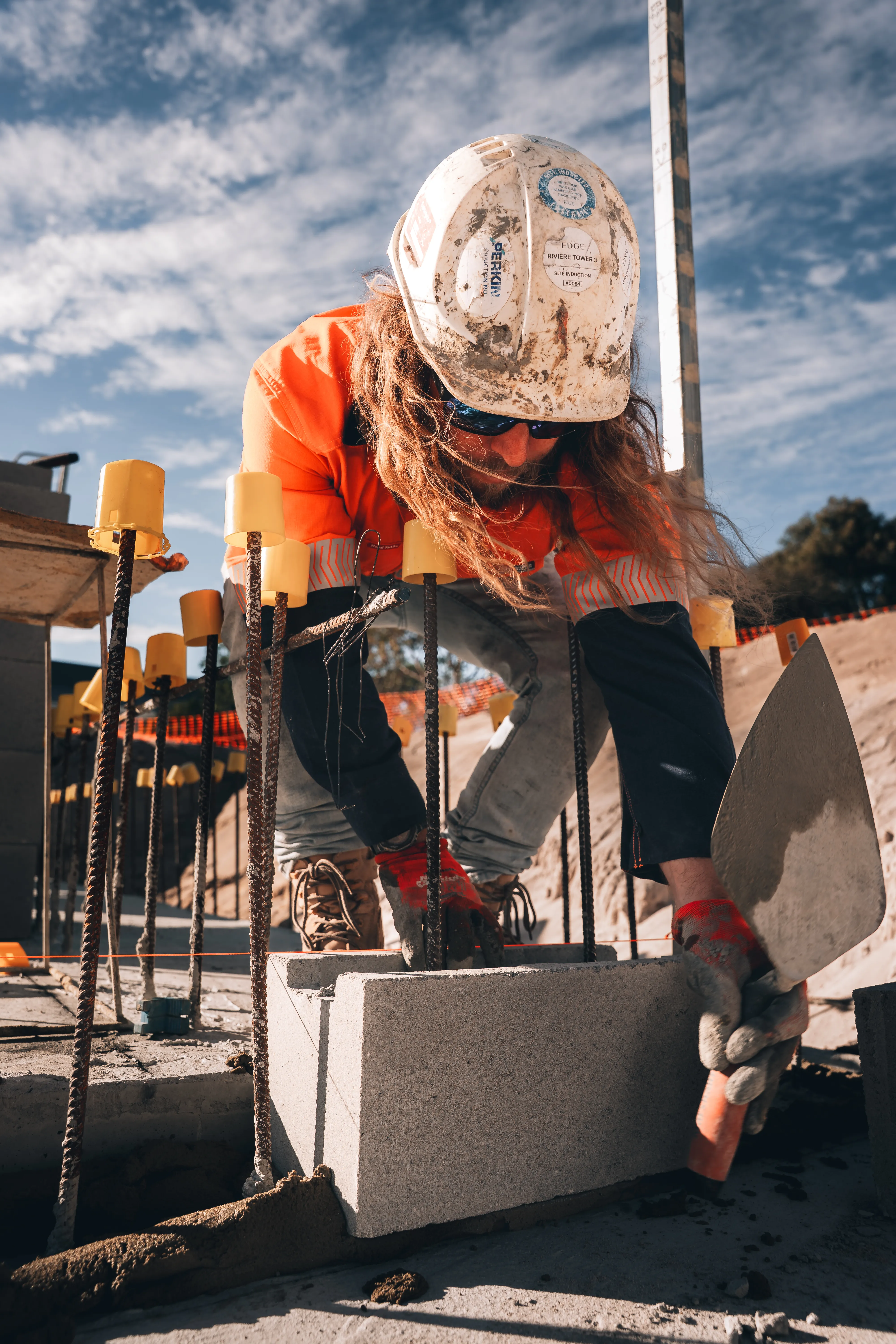 a person in a hard hat and hardhat using a shovel
